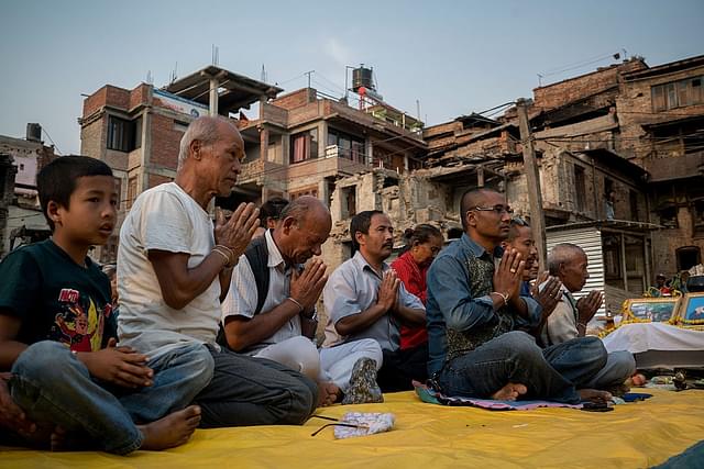 

 Family members of earthquake victims pray during a Buddhist ceremony to commemorate the victims of last year’s earthquake that hit Nepal, on April 24, 2016 in Kathmandu, Nepal. (Photo: Getty)