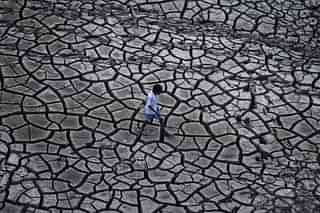 An Indian farmer walks on dry land in a drought-hit area. (Sanjay Kanojia/AFP/Getty Images)