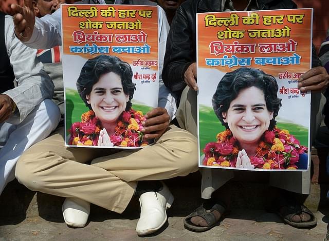 Congress supporters holding posters calling for Priyanka Vadra to lead the party (SAJJAD HUSSAIN/AFP/Getty Images))