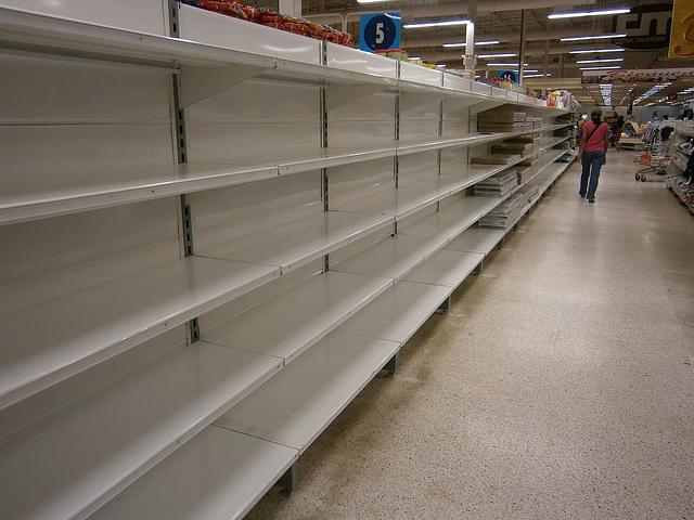 Empty shelves in a store in Venezuela due to shortages. (Wikipedia)