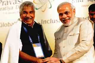 
Narendra Modi shakes hands with Kerala Chief Minister Oommen Chandy (Getty)

