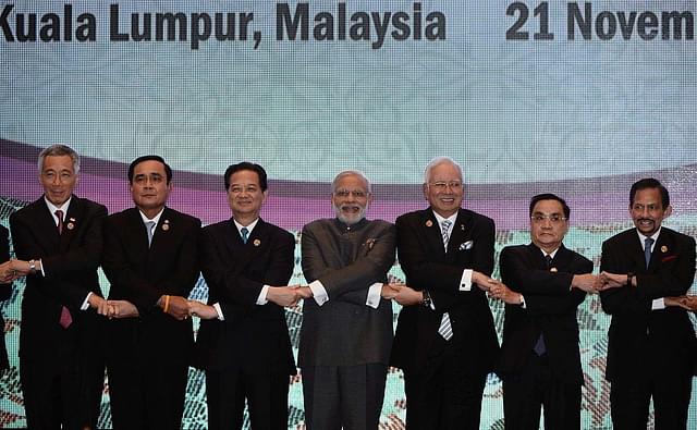 

Prime Minister Narendra Modi (C) joins hands with ASEAN leaders for a group photo during the ASEAN plus India meeting, part of the 27th Association of Southeast Asian Nations (ASEAN) Summit in Kuala Lumpur on November 21, 2015. Asia-Pacific leaders meeting in Malaysia on November 21 condemned the string of Islamic extremist attacks from Paris to Mali, urging an international effort to fight the scourge. Pictured are (L to R) Singapore Prime Minister Lee Hsien Loong, Thailand’s Prime Minister Prayut Chan-O-Cha, Vietnam’s Prime Minister Nguyen Tan Dung, Modi, Malaysia’s Prime Minister Najib Razak, Laos Prime Minister Thongsing Thammavong and Brunei Sultan Hassanal Bolkiah. AFP PHOTO / MANAN VATSYAYANA (Photo credit should read MANAN VATSYAYANA/AFP/Getty Images)
