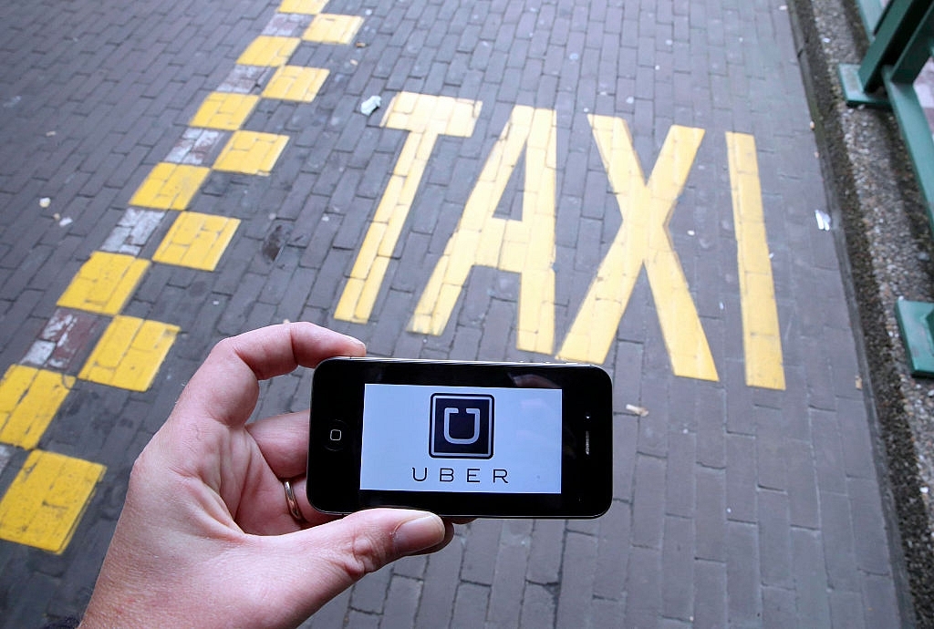 The Uber app on a mobile phone. (NICOLAS MAETERLINCK/AFP/GettyImages)