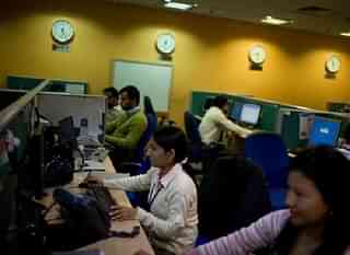 
Indian staff work at a call-centre in Gurgaon on the outskirts of New Delhi. Getty Images 

