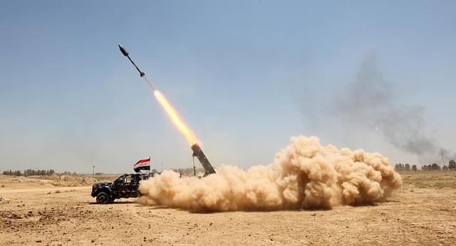 Pro-government forces fighters fire a rocket in the al-Sejar village, in Iraq’s Anbar province, on 27 May 2016, as they take part in a major assault to retake the city of Fallujah, from the Islamic State (IS) group.  AHMAD AL-RUBAYE/AFP/Getty Images