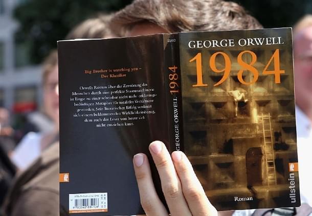 A protester holds a German translation of George Orwell’s book ‘1984’ . Getty Images