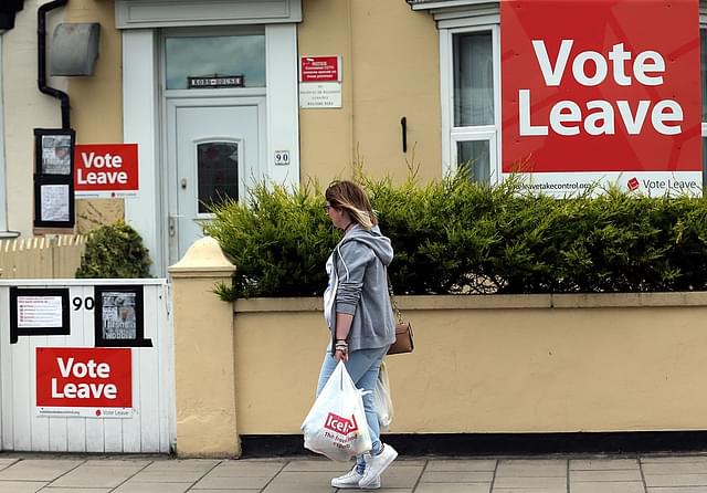 A woman
walks past a house where ‘Vote Leave’ boards are displayed in Redcar, north
east England. (Photo credit: SCOTT HEPPELL/AFP/Getty Images)