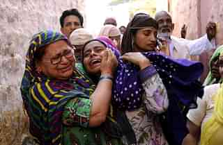 

In this photograph taken on September 29, 2015, relatives mourn slain Indian villager Mohammad Akhlaq in the village of Bisada, some 35 kilometres (22 miles) north-east of New Delhi, after his death at the hands of a mob in the northern state of Uttar Pradesh. Indian police said September 30, 2015, that they had arrested six people after a 50-year-old Muslim man was beaten to death over rumours he had eaten beef, a taboo in the Hindu-majority nation. Mohammad Akhlaq was dragged from his house on the outskirts of the Indian capital New Delhi and attacked by around 100 people late September 28, a police officer told AFP. (Photo credit: STRDEL/AFP/Getty Images)