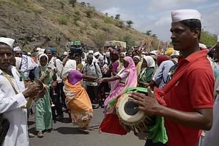 Women and men devotees of Hindu deities <i>Vithoba</i> and his consort <i>Rakhumai</i> (Mother Rukmini) dance in joy as they march as part of annual procession called ‘Wari’ in central-west India. More than 500,000 people of diverse Hindu castes and creeds from different parts of India walk hundreds of miles in Wari each year,  in the month of Āshādh (June–July)