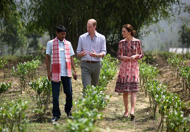 Britain’s Prince William, Duke of Cambridge (C) and Catherine, Duchess of Cambridge speak with an Indian tea-grower during a visit to a village tea garden in Kaziranga, Assam on 13 April 2016. (BIJU BORO/AFP/Getty Images) 
