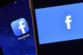 The Facebook app logo is displayed on an iPad next to a picture of the
Facebook logo on an iPhone. Photo credit: 
Carl Court/GettyImages.