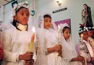 Indian children hold candles as they stand ahead of their first communion during the celebrations of Christmas at a church in Agartala, capital of India’s northeastern state of Tripura, early 25 December 2006. Although Christians make up less than 3 percent of the country’s one-billion-plus population, Christmas is widely celebrated in India. AFP PHOTO (Photo credit: STRDEL/AFP/Getty Images)