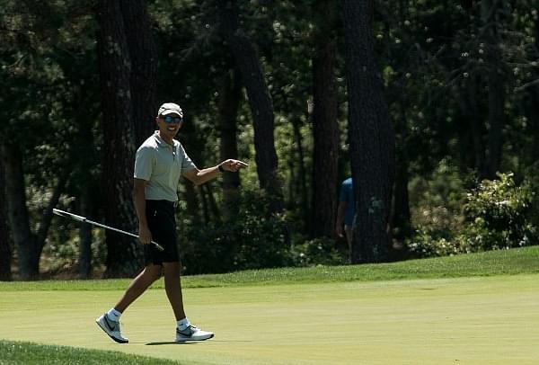 US President Barack Obama reacts to his putt on the first green as he plays golf at Farm Neck Golf Club in Oak Bluffs, Massachusetts on the island of Martha’s Vineyard August 7, 2016. (NICHOLAS KAMM/AFP/Getty Images)