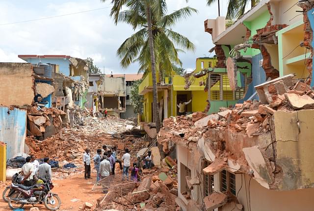 Residents look at the debris of demolished
houses a day after BBMP brought down houses and buildings in Bangalore. Photo
credit:  MANJUNATH KIRAN/AFP/GettyImages