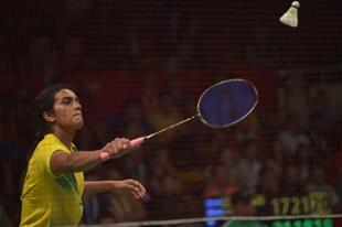 P.V. Sindhu (L) of India hits a return against Li Xuerui of China during their round of 16 women’s singles match of the 2015 World Championships badminton tournament in Jakarta on August 13, 2015. AFP PHOTO / ADEK BERRY (Photo credit should read ADEK BERRY/AFP/Getty Images)