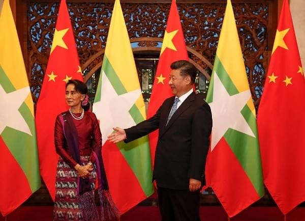 Myanmar State Counsellor Aung San Suu Kyi greets Chinese President Xi Jinping before a meeting at the Diaoyutai State Guesthouse on 19 August 2016 in Beijing, China. (Rolex Dela Pena - Pool/Getty Images)