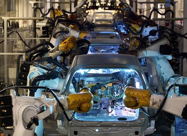 Robots assemble.  
  (Photo credit: JOHN MACDOUGALL/AFP/Getty Images)
