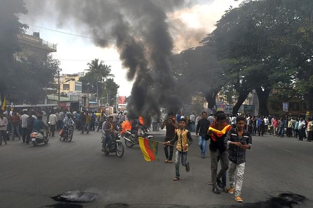 Protesters burn tyres as they blockade traffic on a major
connecting road during a statewide strike in Bangalore over the Cauvery water
issue. Photo credit: MANJUNATH KIRAN/AFP/GettyImages 