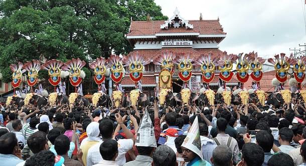 Thousands of Pooram fans watch the processions led by caparisoned
elephants in front of Vadakkunnathan
Temple in  Thrissur. Photo
credit: STRDEL/AFP/GettyImages
