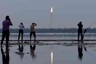 Indian residents photograph the launch of the ISRO PSLV-C35 (ARUN SANKAR/AFP/Getty Images)