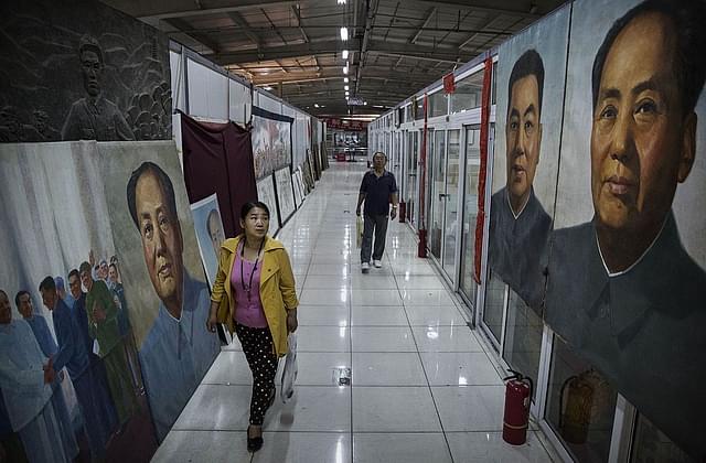 A Chinese looks at large portraits of the late Mao Zedong
outside a sale and auction of memorabilia dedicated to him in Beijing. Photo credit:
Kevin Frayer/GettyImages