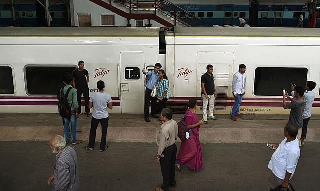 Indian
bystanders gather near train coaches from Spanish manufacturer Talgo after
their arrival at Mumbai Central train terminal for trial runs. (PUNIT
PARANJPE/AFP/Getty Images)