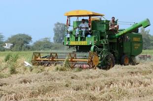 Indian farmers use a combine harvester (
Photo By: NARINDER NANU/AFP/Getty Images)