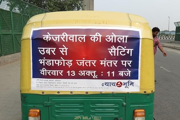 A poster on an auto rickshaw - Kejriwal ki Ola Uber se Setting