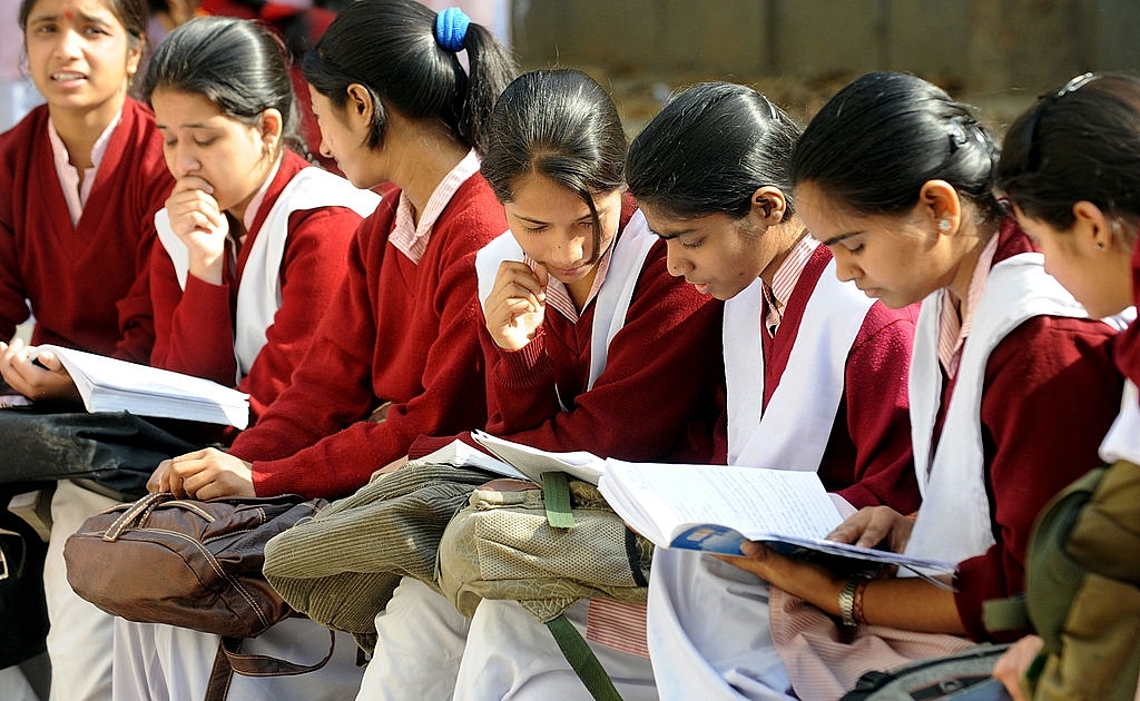 School children prepare for their CBSE senior school certificate 
examinations before entering an examination hall in New Delhi 