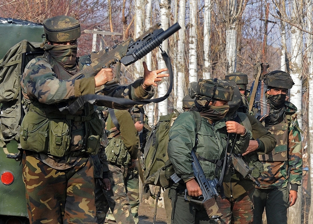 
Indian Army soldiers stand near the scene of a gun battle.<br> (Photo By: 
TAUSEEF MUSTAFA/AFP/Getty Images)

