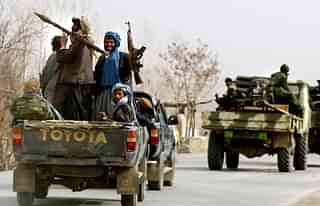 
Northern Alliance soldiers ride a vehicle. (Photo 
by Paula Bronstein/Getty Images)

