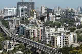 A Mumbai Metro train passes through a residential area (INDRANIL MUKHERJEE/AFP/Getty Images)
