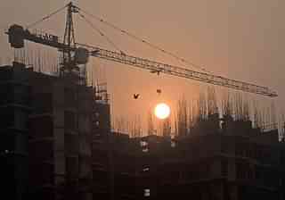 Sun rises over an under-construction apartment building on the outskirts of New Delhi. (PRAKASH SINGH/AFP/Getty Images)