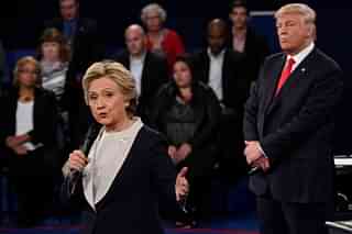 Republican nominee Donald Trump (R) watches Democratic nominee Hillary Clinton during the second presidential debate at Washington University in St. Louis, Missouri (SAUL LOEB/AFP/Getty Images)