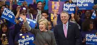 

Democratic presidential hopeful Hillary Clinton waves to the crowd beside Virginia Governor Terry McAuliffe during a campaign rally February 29, 2016 at George Mason University in Fairfax, Virginia (Photo credit: PAUL J. RICHARDS/AFP/Getty Images)