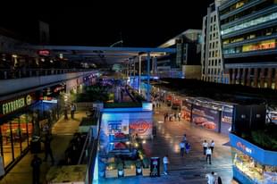 In this photograph taken on May 11, 2016, Indian visitors walk around the DLF CyberHub located in DLF Cyber City of Gurgaon located 32 kilometers southwest of New Delhi. The satellite town of Gurgaon near the Indian capital is home to scores of top multinational companies, and the influx of foreign capital has brought with it gleaming shopping malls enjoyed by India’s rising middle class seeking an outlet for their disposable income. / AFP / CHANDAN KHANNA (Photo credit: CHANDAN KHANNA/AFP/Getty Images)