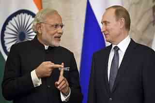 Russian President Vladimir Putin (R) listens to India’s Prime Minister Narendra Modi during a ceremony. (ALEXANDER NEMENOV/AFP/Getty Images)