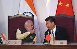 Prime Minister Narendra Modi (L) gestures while talking with China’s President Xi Jingping during the BRICS leaders’ meeting (PRAKASH SINGH/AFP/Getty Images)
