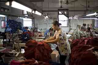 Workers sew t-shirts in a factory in Zhujiajiao, on the outskirts of Shanghai, China. (FRED DUFOUR/AFP/Getty Images)