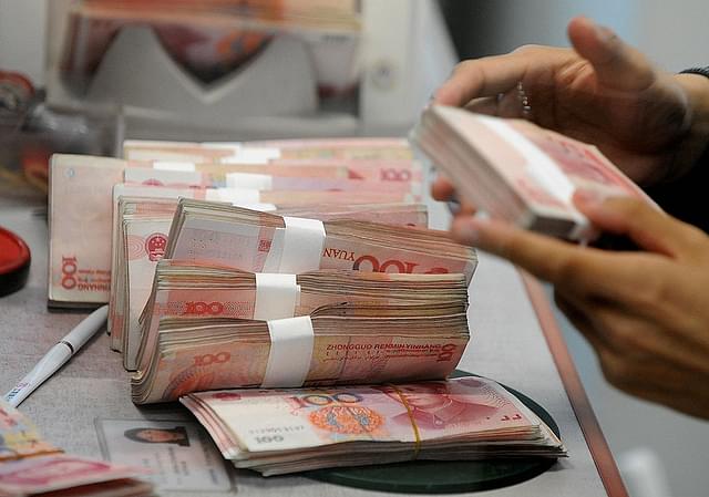 Chinese 100 Yuan notes are counted at a bank in Shanghai.  Photo credit: MARK
RALSTON/AFP/GettyImages