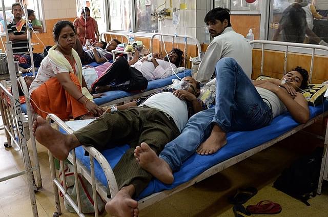 Indian patients share a bed in a dengue ward of Hindu Rao
hospital in New Delhi. Photo credit: PRAKASH SINGH/AFP/GettyImages
