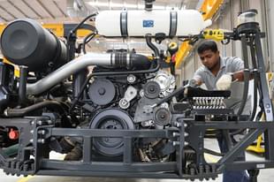 A worker assembles a bus at a manufacturing facility in Bengaluru. Photo credit: MANJUNATH KIRAN/AFP/GettyImages