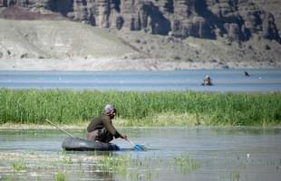 An Afghan man fishes on a tyre at the Kabul river in Surobi 
district. (Photo Credit: JOHANNES 
EISELE/AFP/Getty Images)