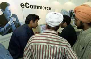 
 Fair-goers are explained the finer points of e-commerce.  (Photo credit should read JOHN MACDOUGALL/AFP/Getty Images)
