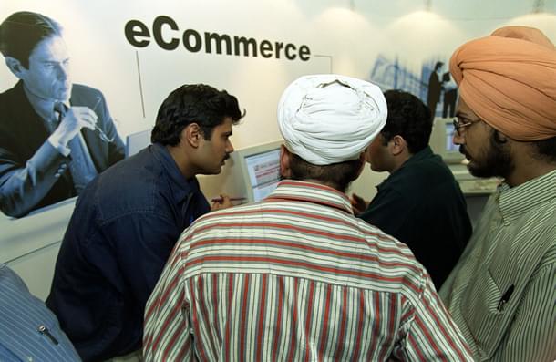 Fair-goers are explained the finer points of e-commerce. (Photo credit should read JOHN MACDOUGALL/AFP/Getty Images)