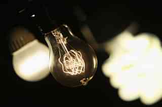 A vintage-style incandescent light bulb (C), with an LED light bulb (L) and a compact florescent (CFL) light bulb (Scott Olson/Getty Images)