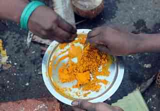 
Indian Hindu devotees prepare a paste from turmeric powder. (Photo Credit: INDRANIL 
MUKHERJEE/AFP/Getty Images)

