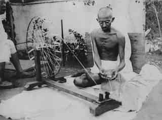 Mahatma Gandhi spinning yarn, in the late 1920s (Wikimedia Commons)