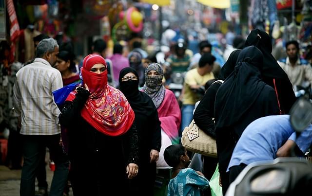 Muslim shoppers walk through a market in Bhopal. Photo credit: MONEY SHARMA/AFP/GettyImages