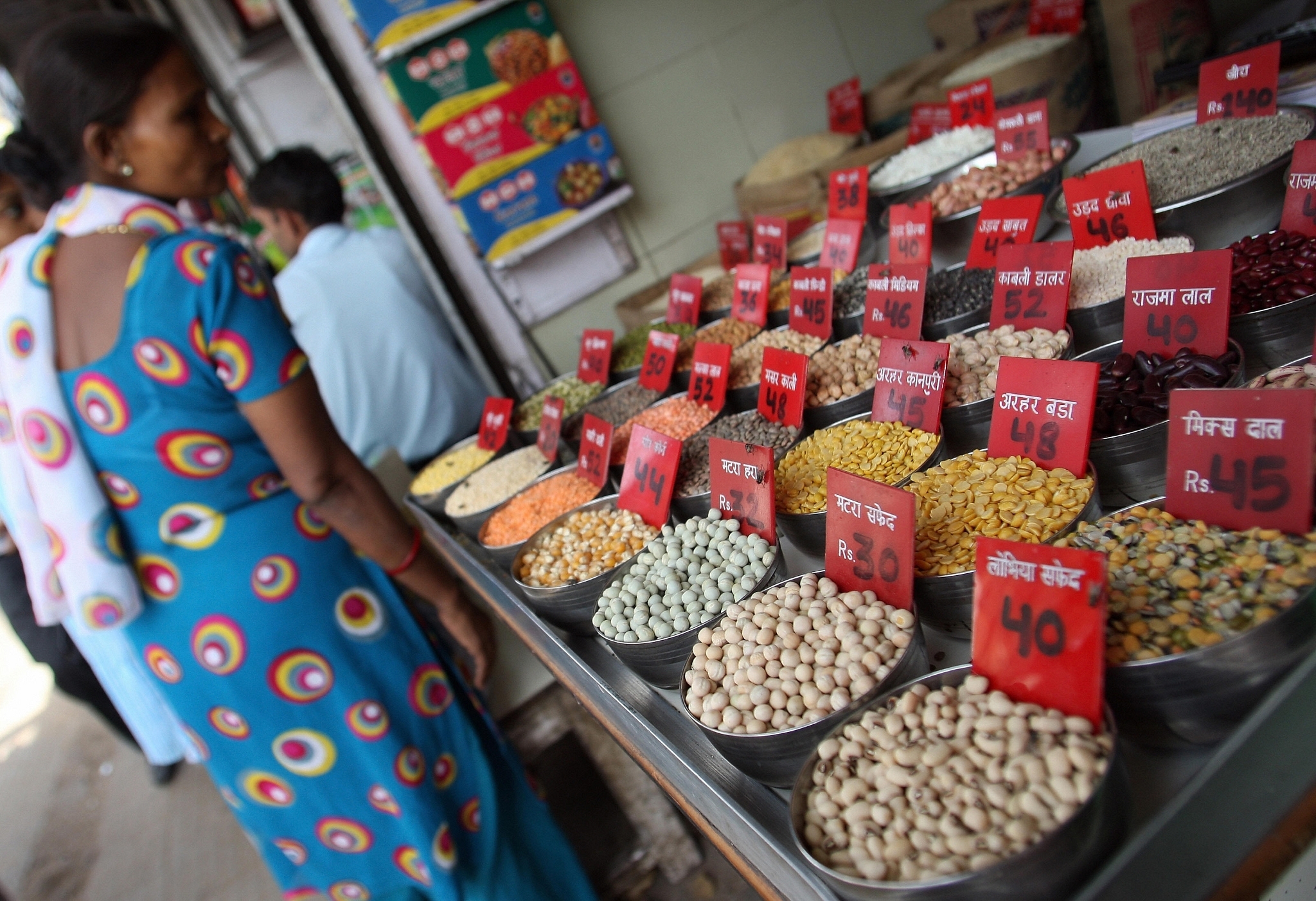 
A woman checks the price of pulses and grains at a 
wholesale market in New Delhi. Photo Credit: MANAN VATSYAYANA/AFP/Getty Image